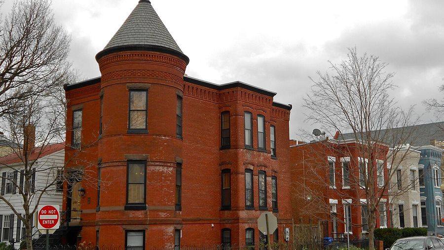 Red-brick corner building with a turret on a Washington, DC street