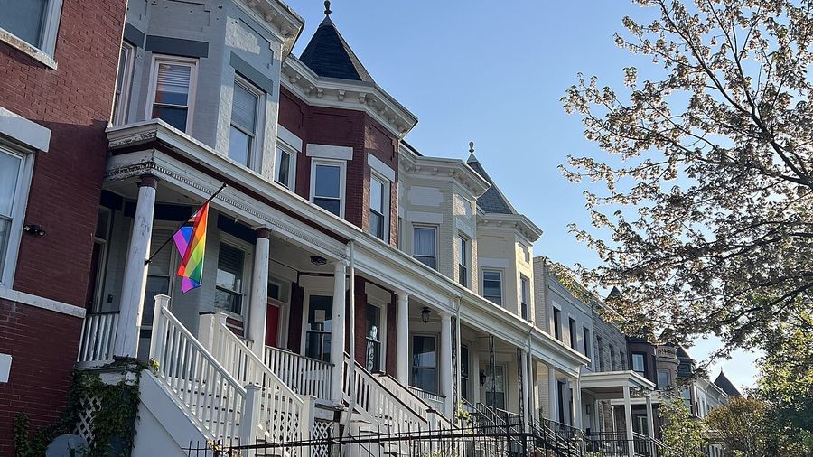 Row of DC rowhouses with front porches, several converted to multiple units