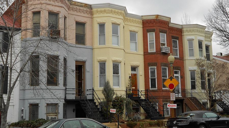 Block of painted rowhouses with front stoops in Washington, DC