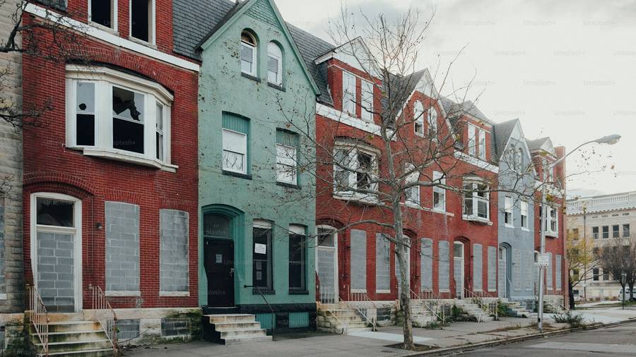 Row of brick townhouse investment properties on a city street