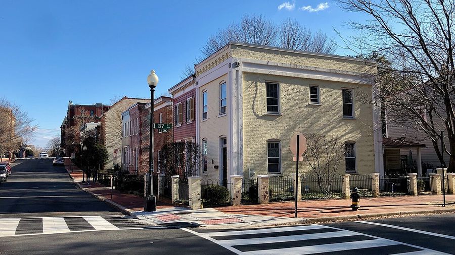 Corner rowhouse and crosswalk on a quiet Washington, DC street